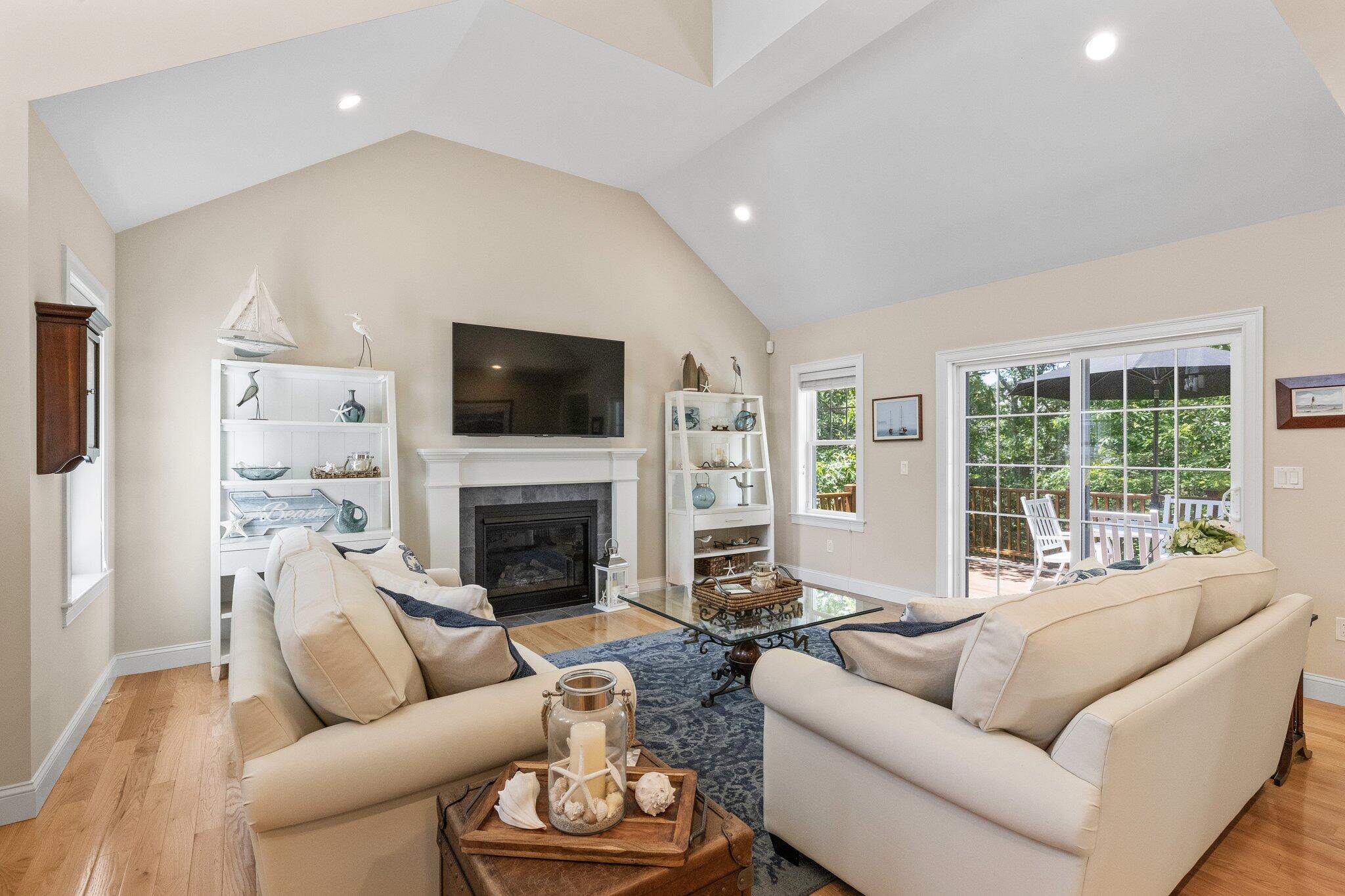 22 Saltwater Circle Mashpee, MA 02649 - Photo 8 of 53 a living room with furniture a fireplace and a flat screen tv