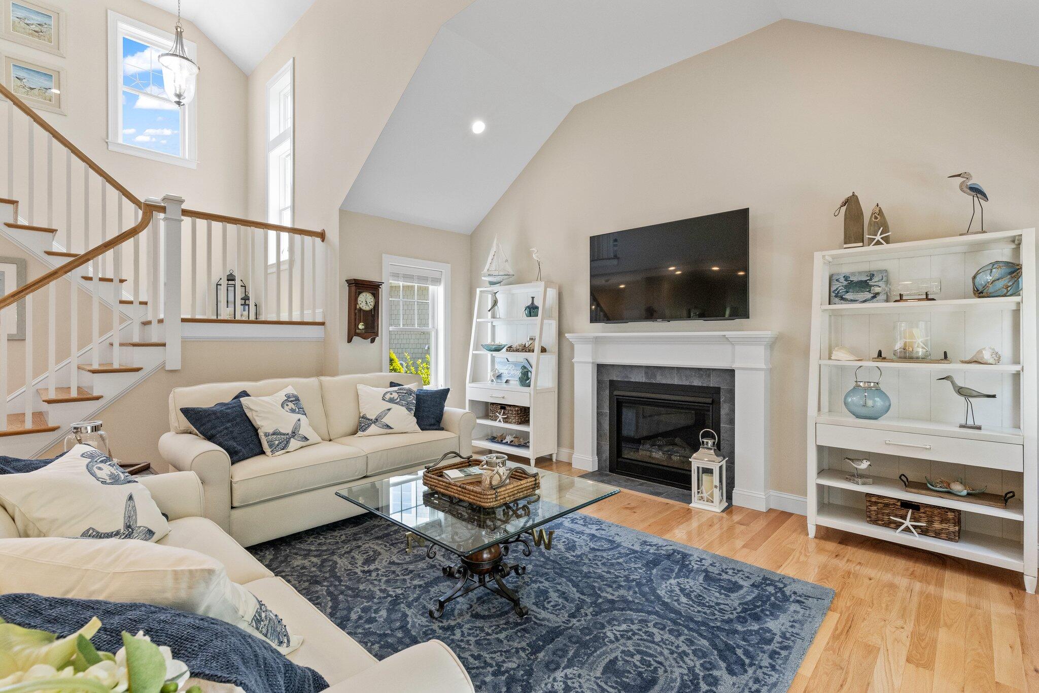 22 Saltwater Circle Mashpee, MA 02649 - Photo 9 of 53 a living room with furniture a flat screen tv and a fireplace