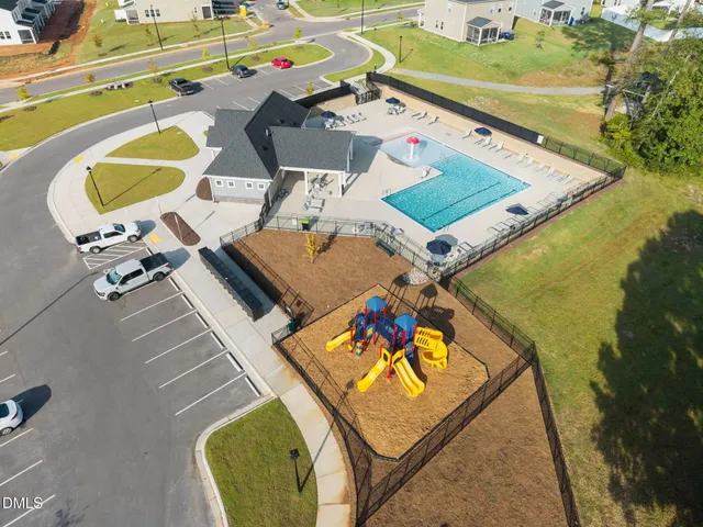 a kitchen with stainless steel appliances kitchen island granite countertop a stove a refrigerator a sink a microwave oven with wooden floor and cabinets