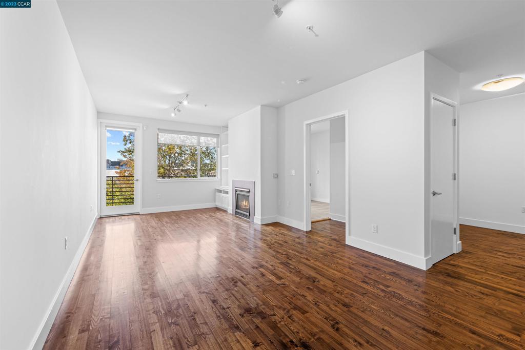 2300 Broadway Oakland, CA 94612 - Photo 12 of 32 a view of an empty room with window and wooden floor