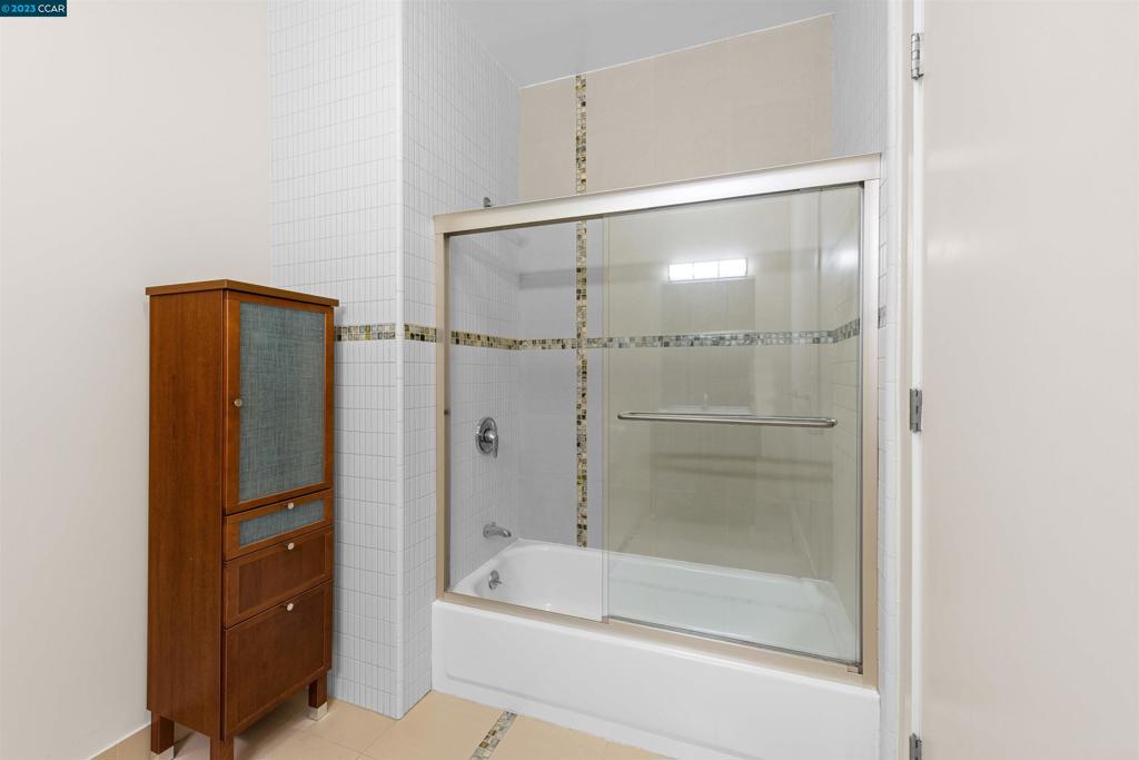 2300 Broadway Oakland, CA 94612 - Photo 17 of 32 a bathroom with a bathtub and a shower