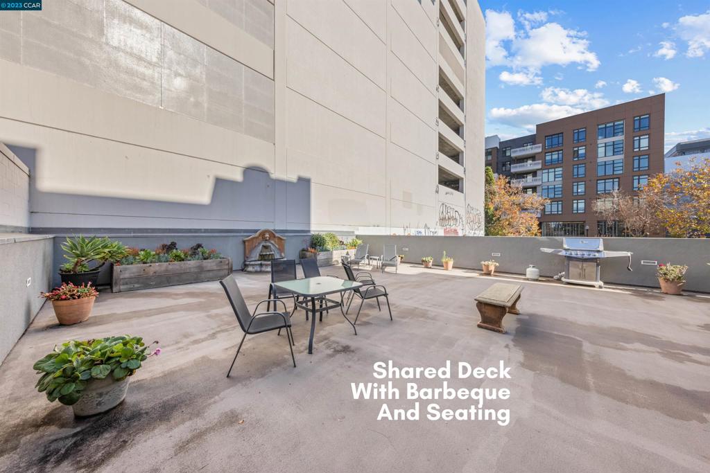2300 Broadway Oakland, CA 94612 - Photo 22 of 32 a view of a patio with a table and chairs and potted plants
