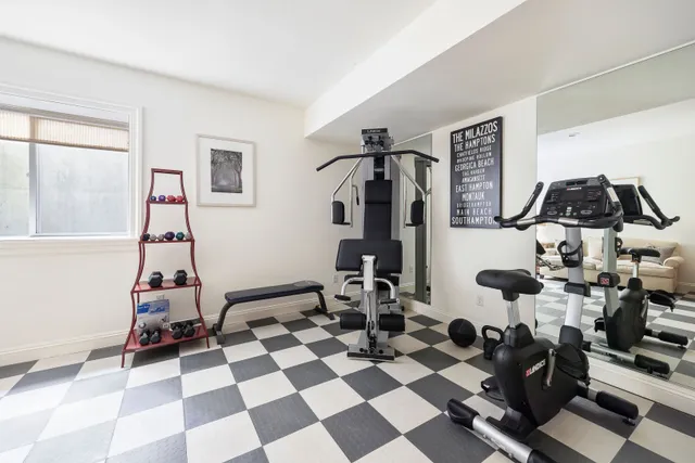 a room with gym equipment and black white checkered floor