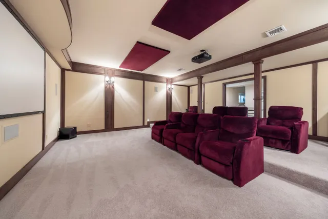 a living room with furniture a red couch and a large window