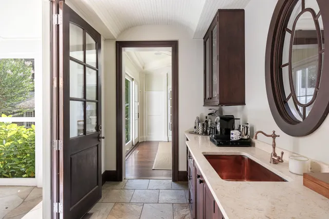 a kitchen with granite countertop a sink and a refrigerator