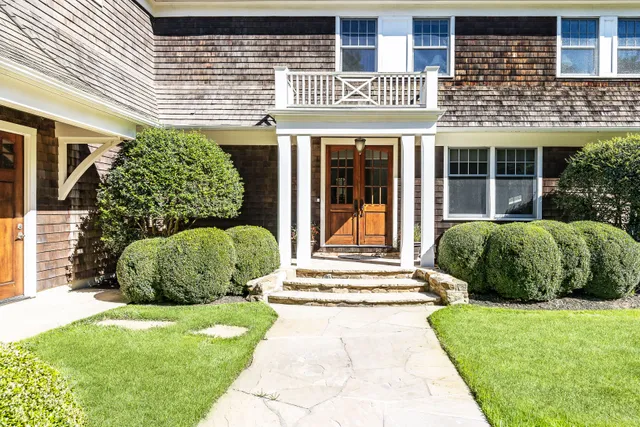 a front view of a house with a garden