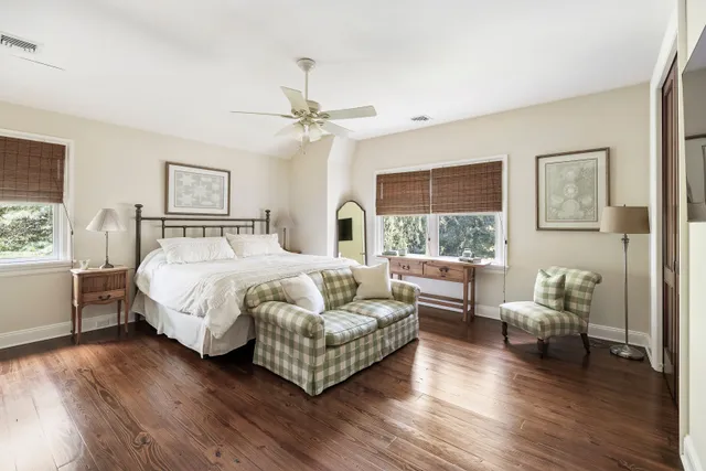 a bedroom with a bed couch and a window