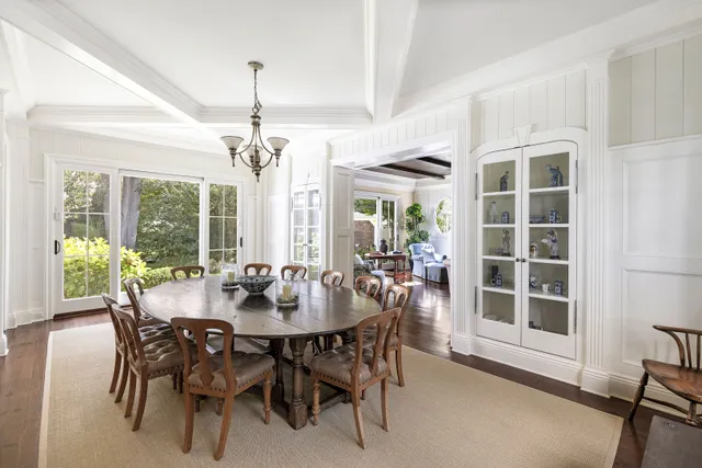 a view of a dining room with furniture wooden floor and chandelier