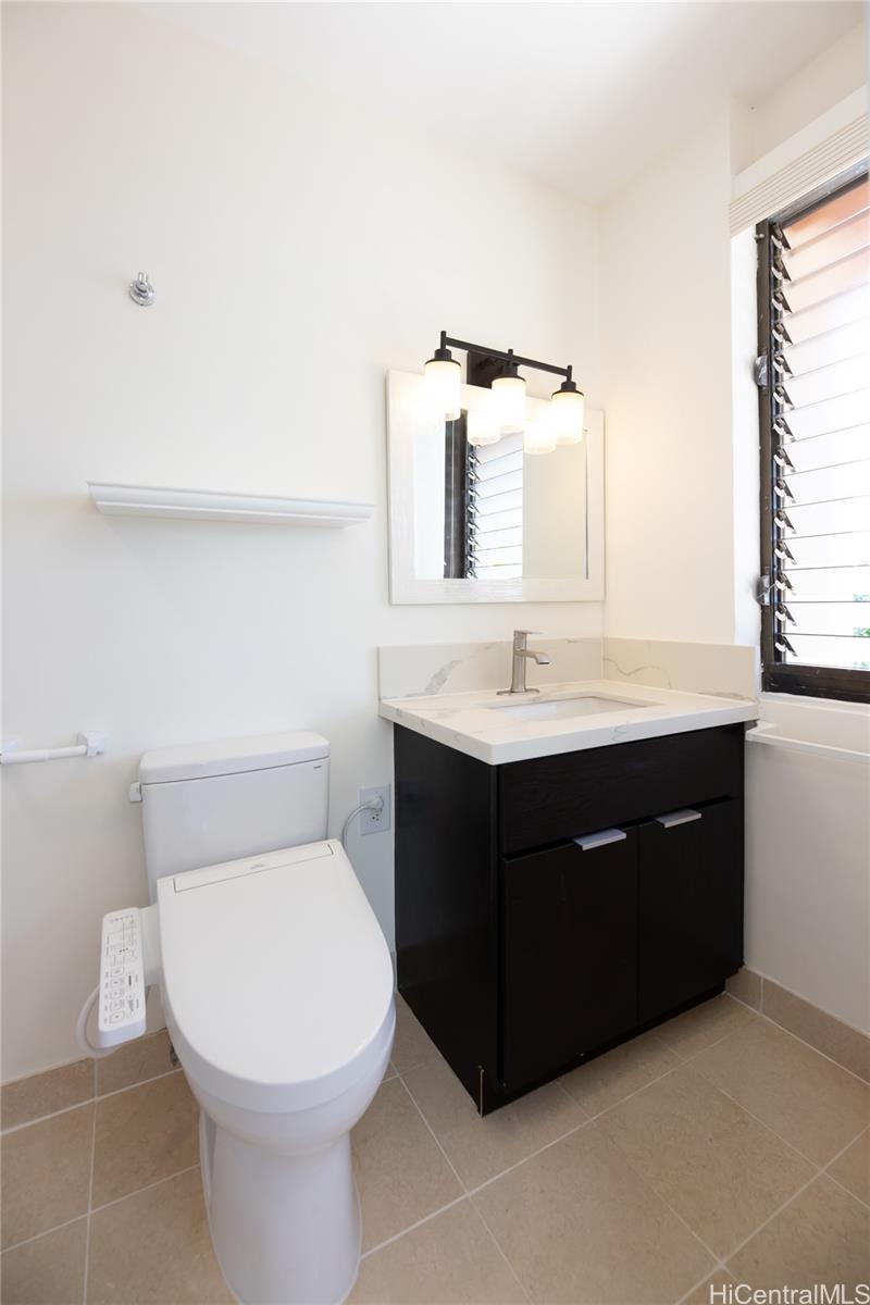 1632 Ihiloa Loop Honolulu, HI 96821 - Photo 21 of 24 a bathroom with a sink vanity mirror and toilet