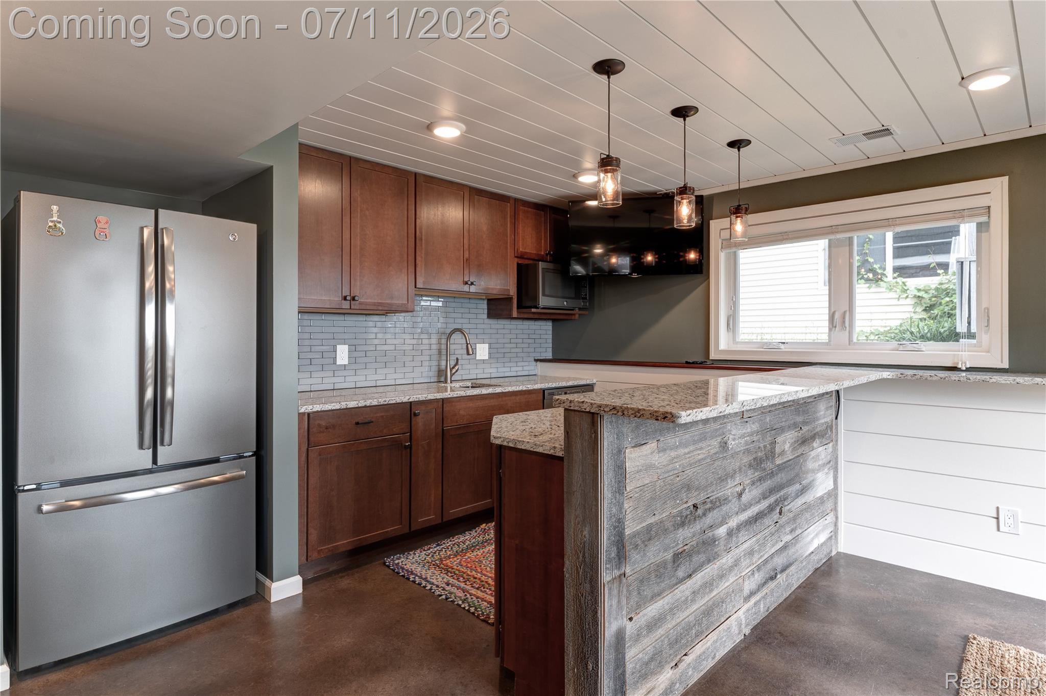 12033 Torrey Road Fenton, MI 48430 - Photo 36 of 51 Kitchenette featuring stainless steel refrigerator, wood cabinetry, granite countertops, tile backsplash, and a shiplap ceiling