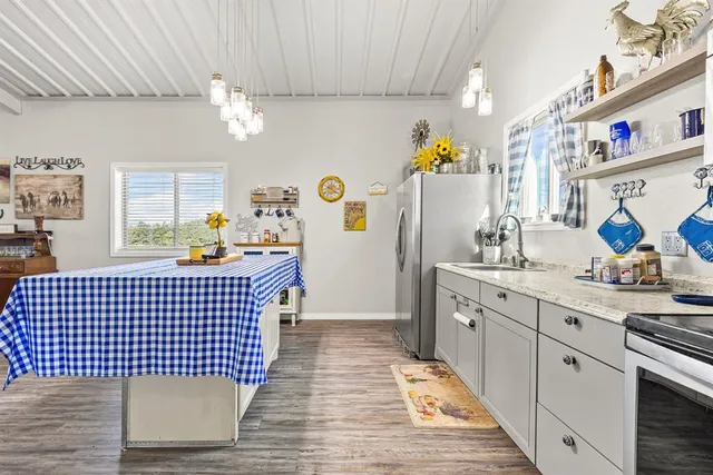 a spacious bedroom with a bed a couch and a large window