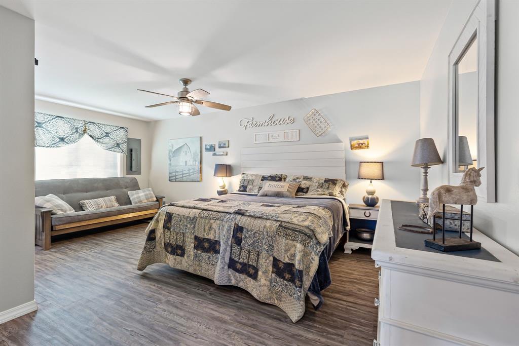 1094-2 Southwest Sw Cr Saltillo, TX 75478 - Photo 18 of 39 a spacious bedroom with a bed a couch and a large window