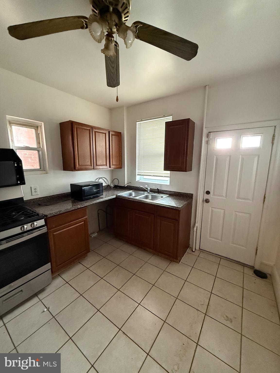 3309 Brighton Street Baltimore, MD 21216 - Photo 19 of 32 a large kitchen with stainless steel appliances granite countertop a sink and cabinets