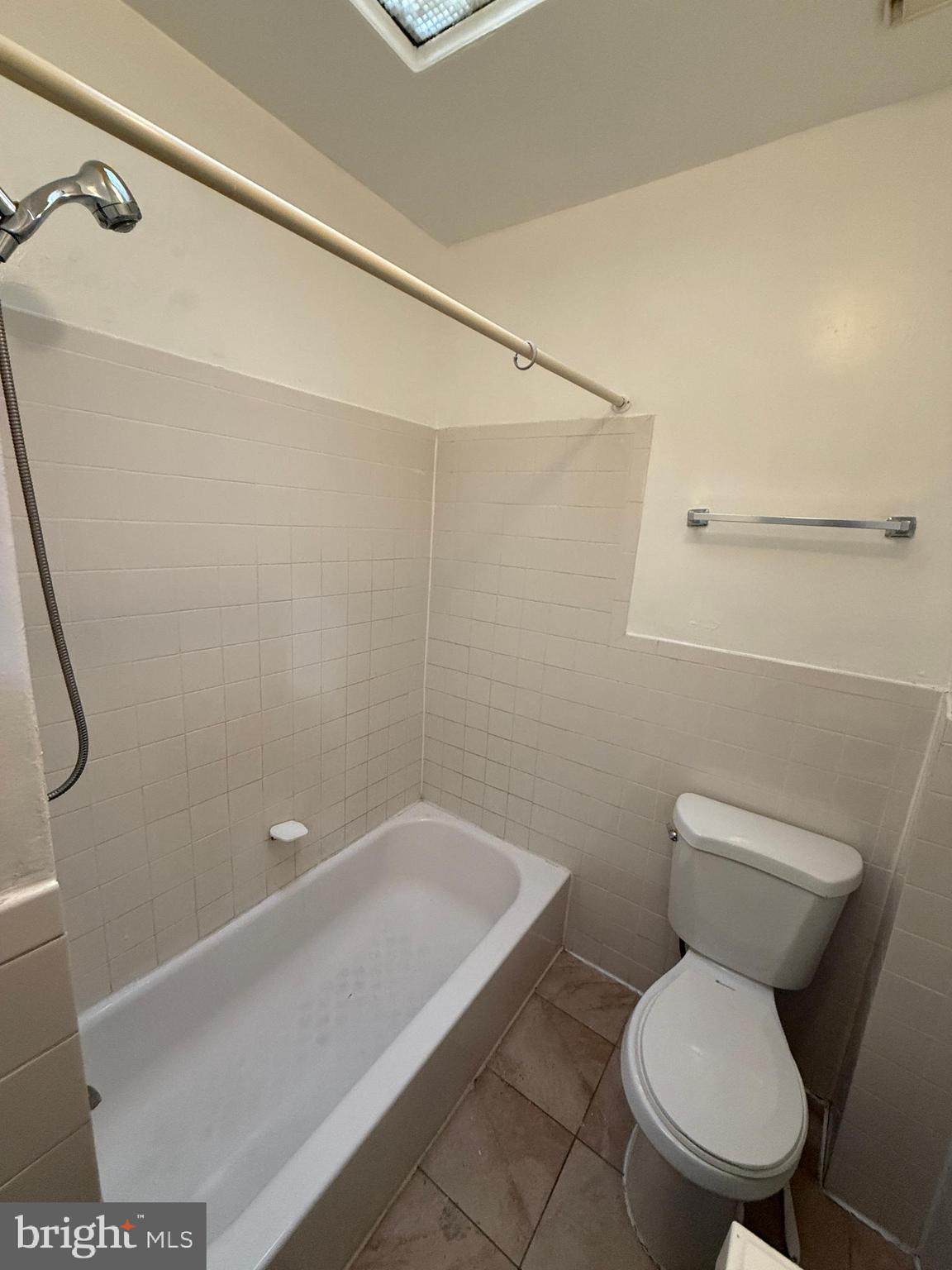 3309 Brighton Street Baltimore, MD 21216 - Photo 20 of 32 a white toilet sitting next to a bathroom sink