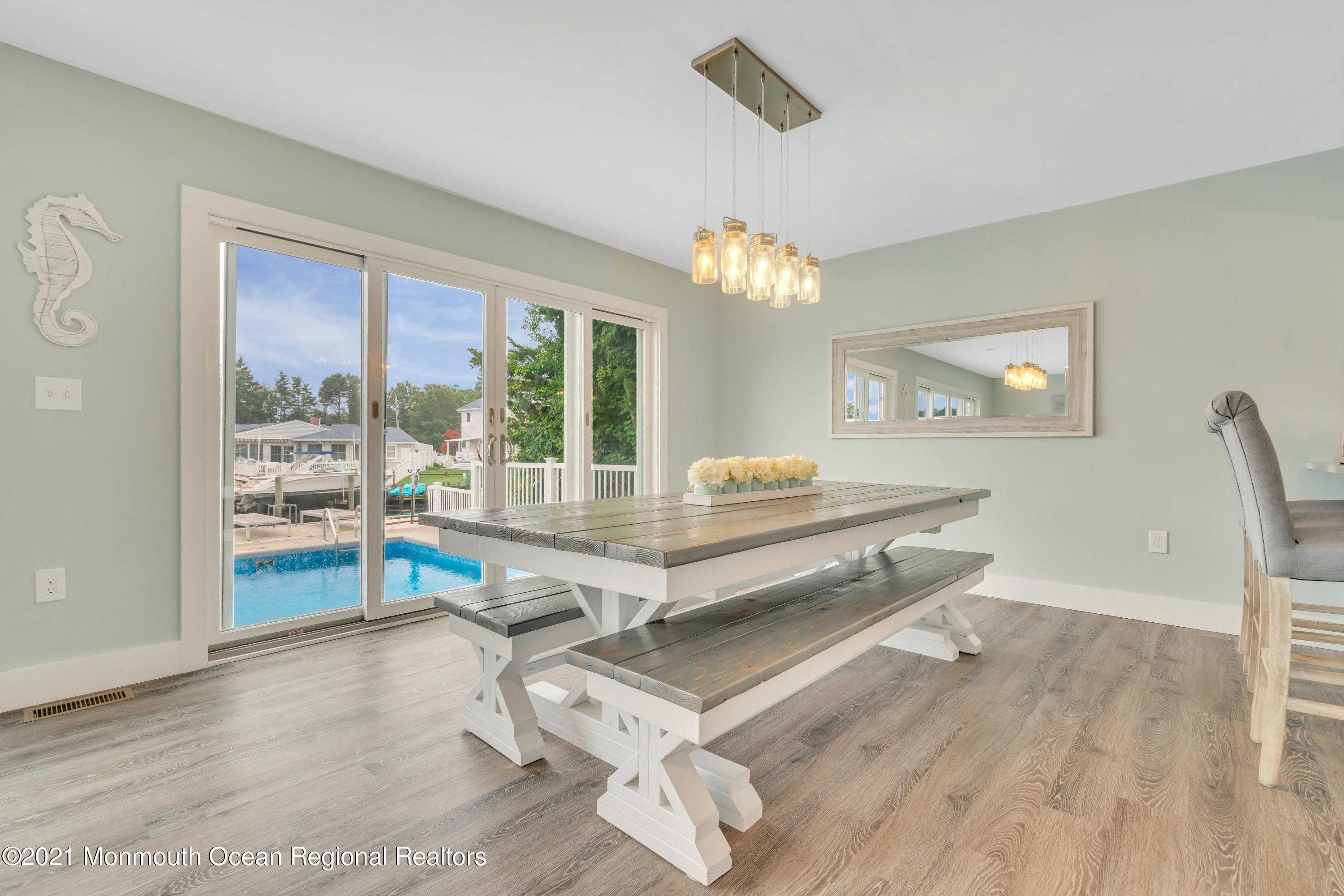 28 Harbor Inn Road Bayville, NJ 08721 - Photo 16 of 52 a living room with furniture a chandelier and a table