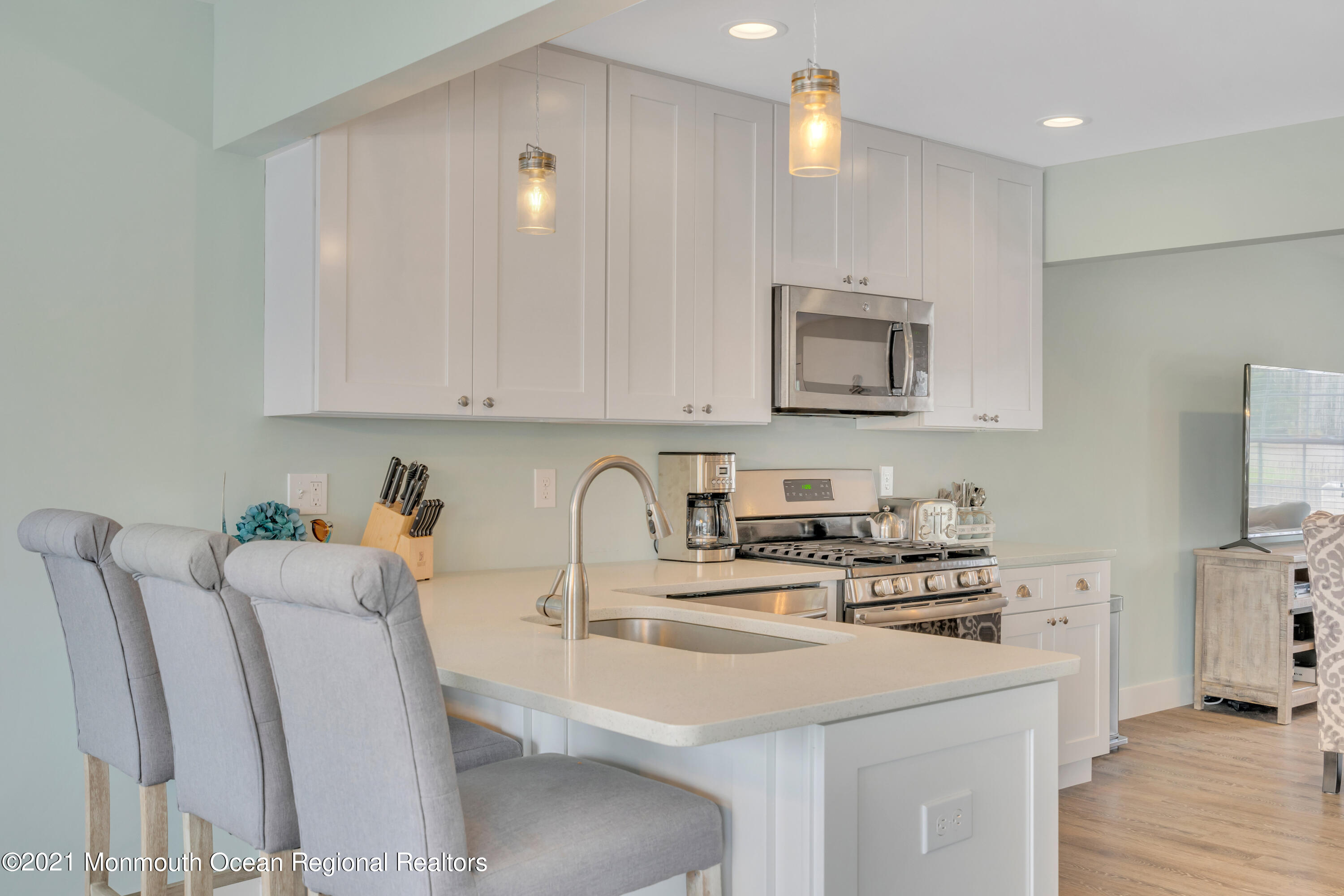 28 Harbor Inn Road Bayville, NJ 08721 - Photo 18 of 52 a kitchen with stainless steel appliances a white stove top oven a sink a refrigerator and white cabinets with wooden floor