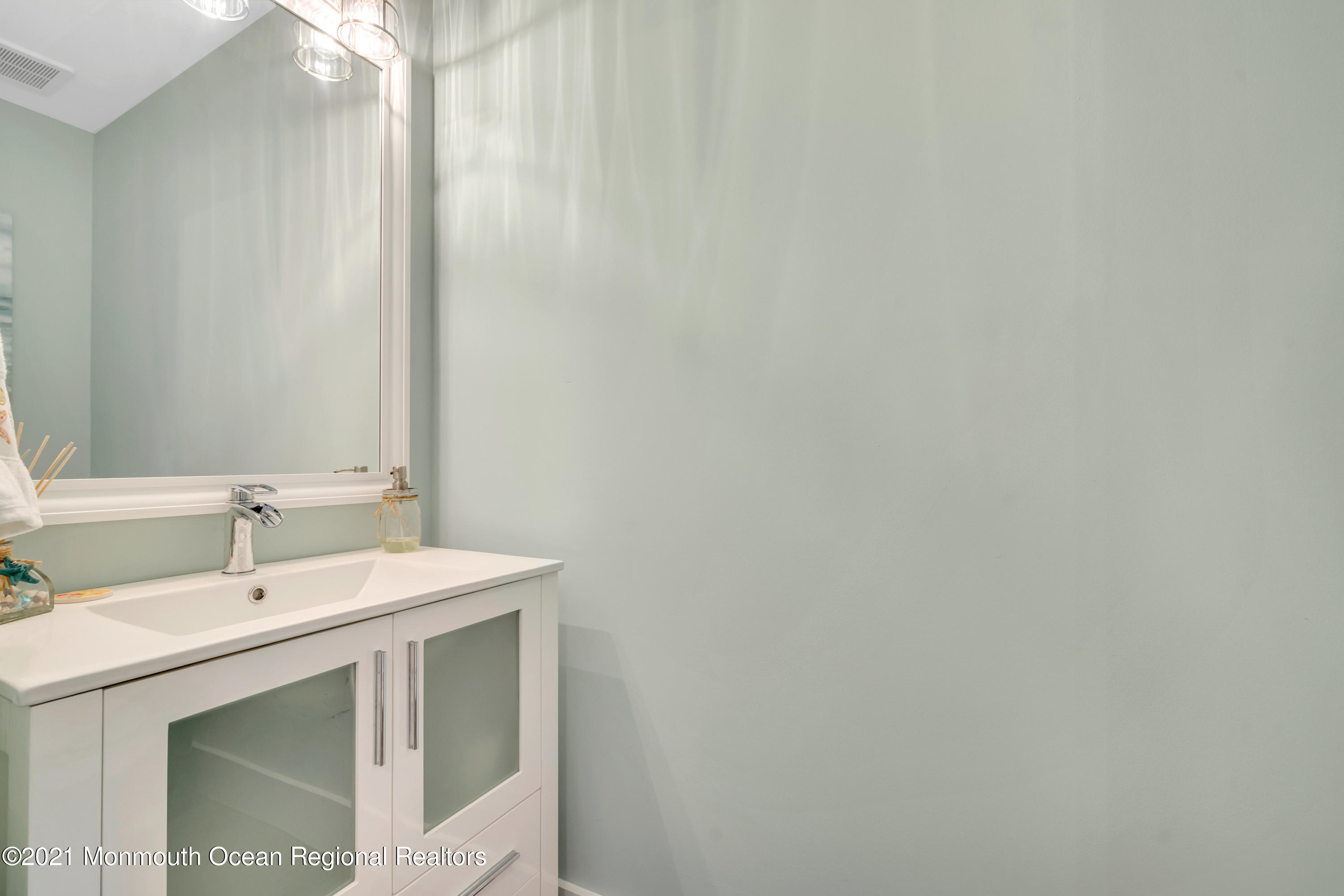 28 Harbor Inn Road Bayville, NJ 08721 - Photo 28 of 52 a bathroom with a sink and a mirror