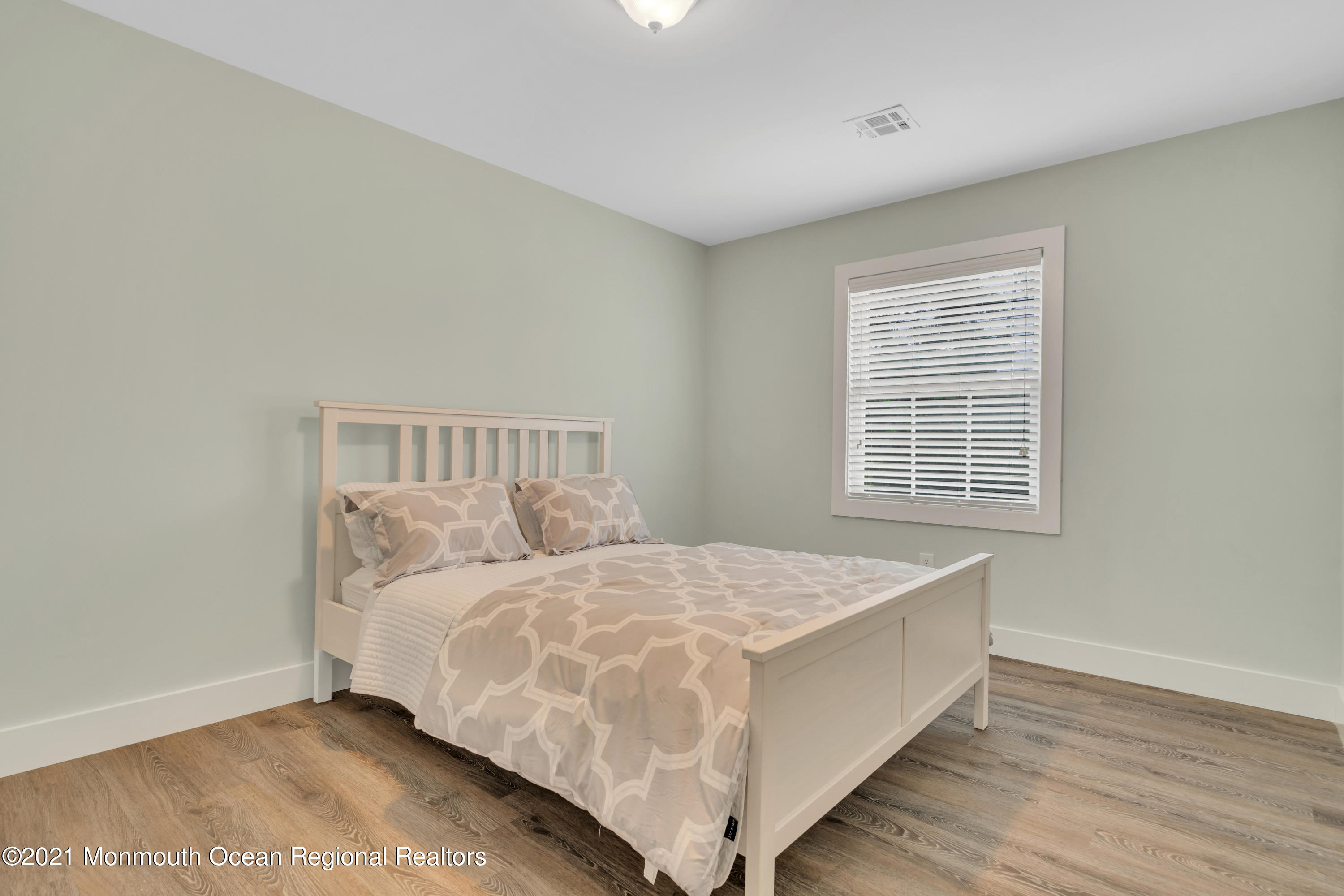 28 Harbor Inn Road Bayville, NJ 08721 - Photo 35 of 52 a bed sitting in a bedroom next to a window