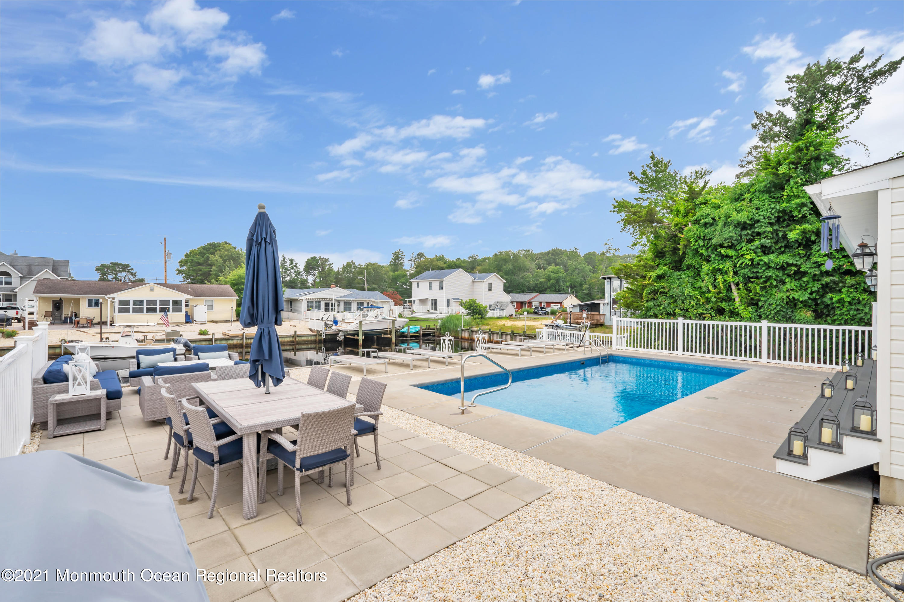 28 Harbor Inn Road Bayville, NJ 08721 - Photo 40 of 52 a view of a swimming pool with outdoor seating and plants