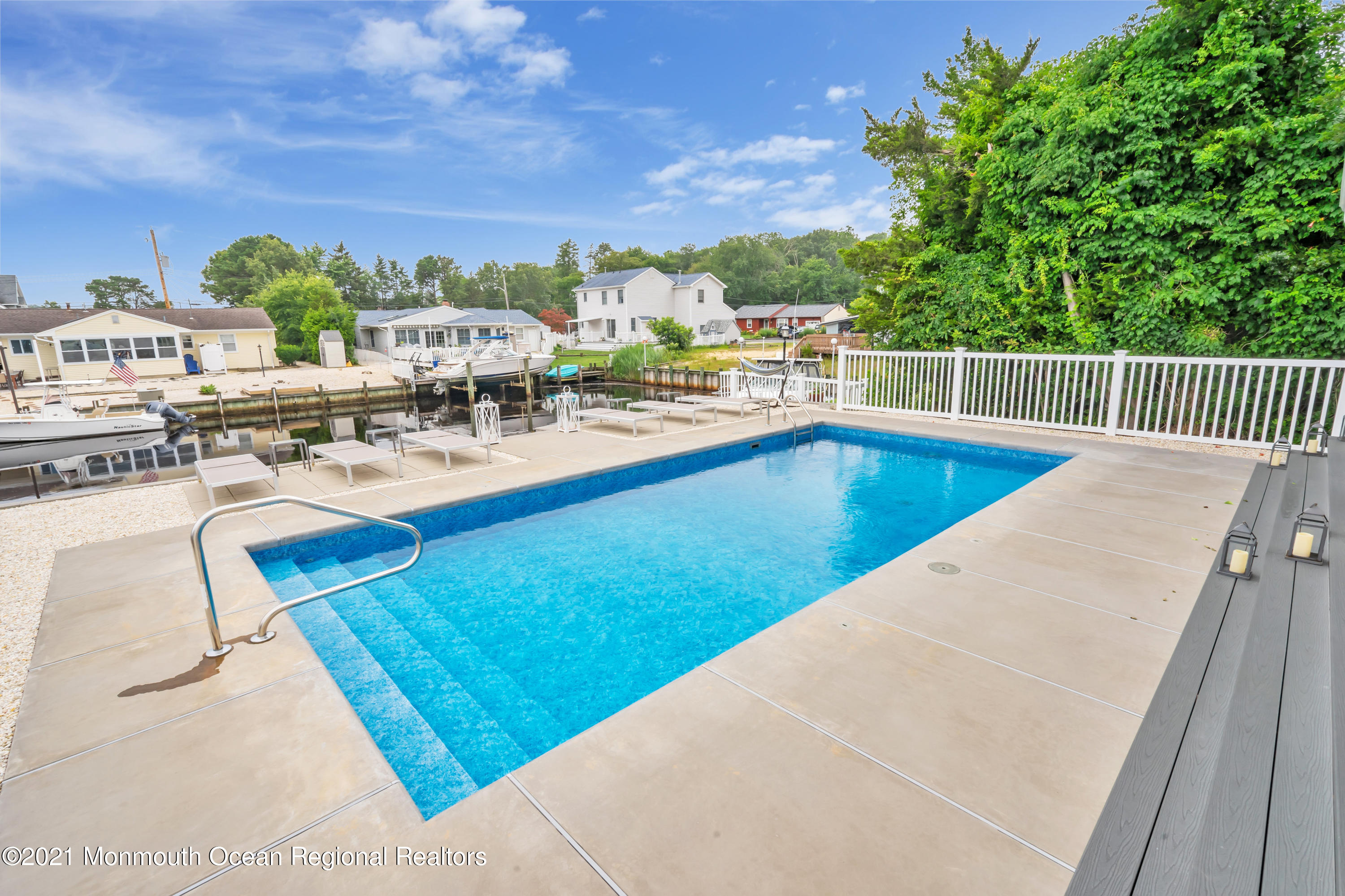 28 Harbor Inn Road Bayville, NJ 08721 - Photo 41 of 52 a view of a swimming pool with outdoor seating