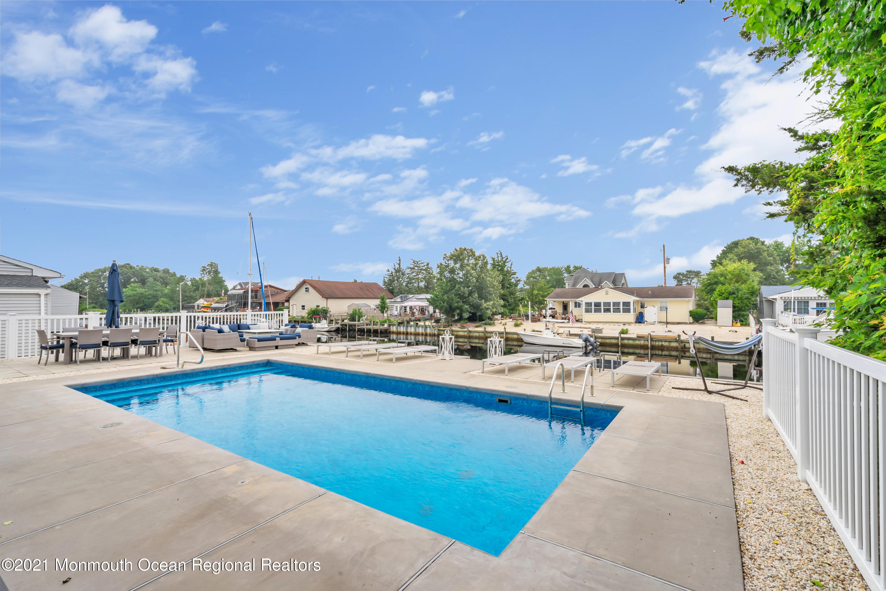 28 Harbor Inn Road Bayville, NJ 08721 - Photo 42 of 52 a view of a swimming pool and lounge chairs