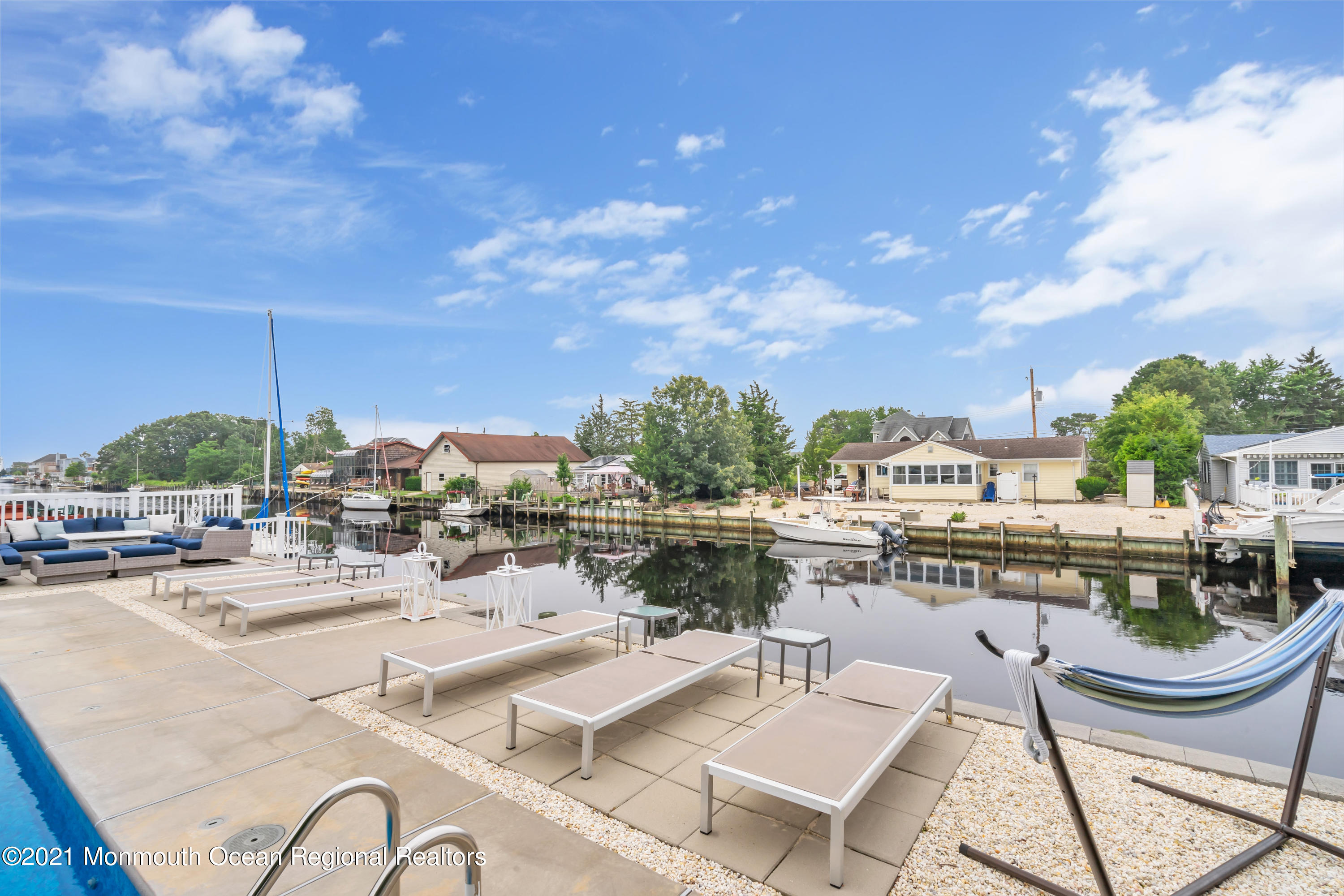 28 Harbor Inn Road Bayville, NJ 08721 - Photo 43 of 52 a view of a swimming pool with outdoor seating and plants