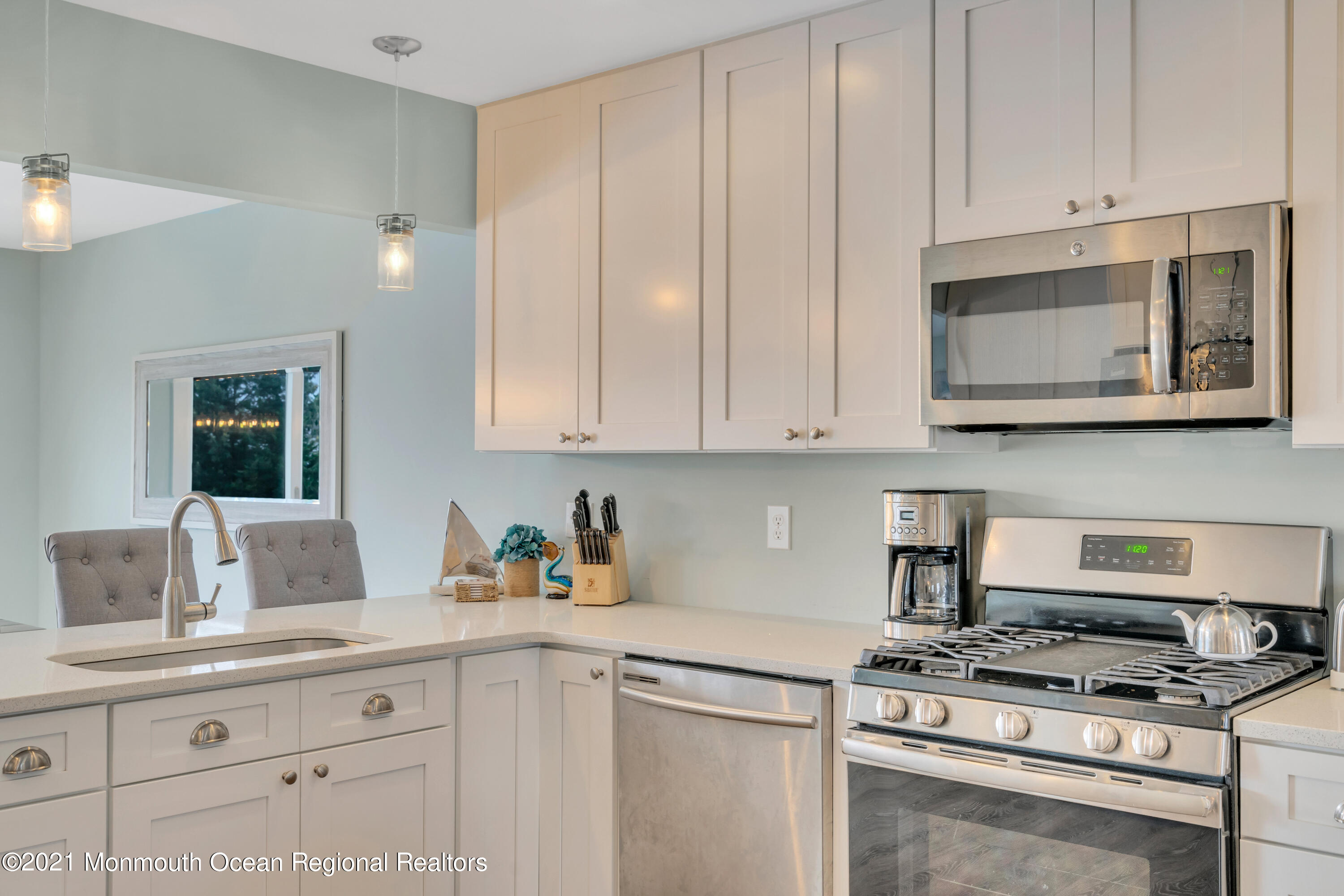 28 Harbor Inn Road Bayville, NJ 08721 - Photo 10 of 52 a kitchen with stainless steel appliances granite countertop white cabinets and a stove top oven