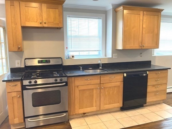 5 Shafter Street, Unit 1 Boston, MA 02121 - Photo 2 of 5 a kitchen with granite countertop cabinets stainless steel appliances and a window