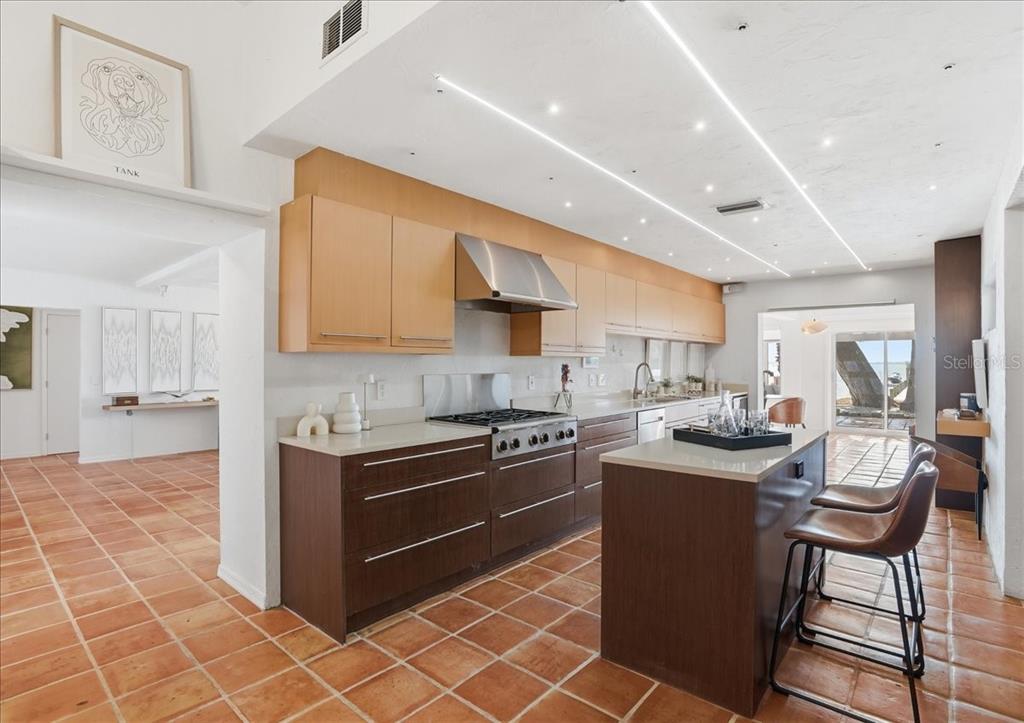 3127 Bay Shore Road Sarasota, FL 34234 - Photo 27 of 78 a kitchen with stainless steel appliances granite countertop a sink a stove a microwave a counter top space and cabinets