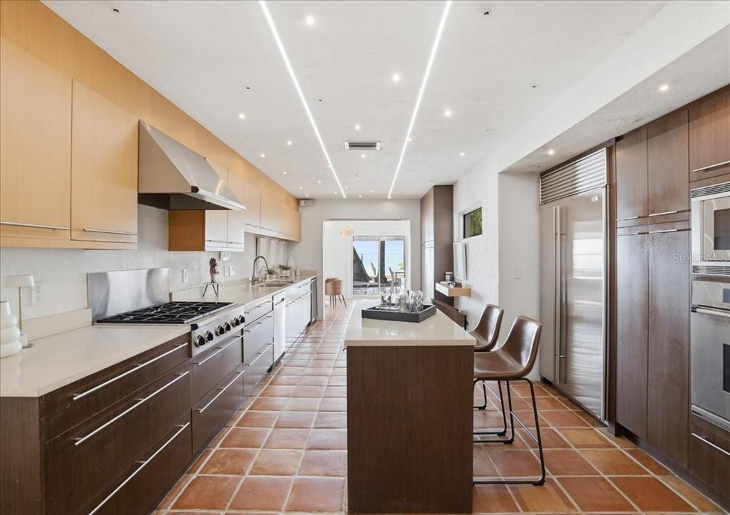 3127 Bay Shore Road Sarasota, FL 34234 - Photo 28 of 78 a large kitchen with stainless steel appliances lots of counter space and breakfast area