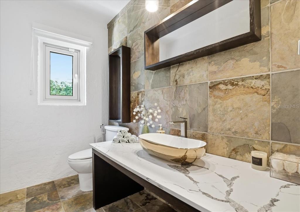 3127 Bay Shore Road Sarasota, FL 34234 - Photo 35 of 78 a bathroom with a sink a toilet and mirror