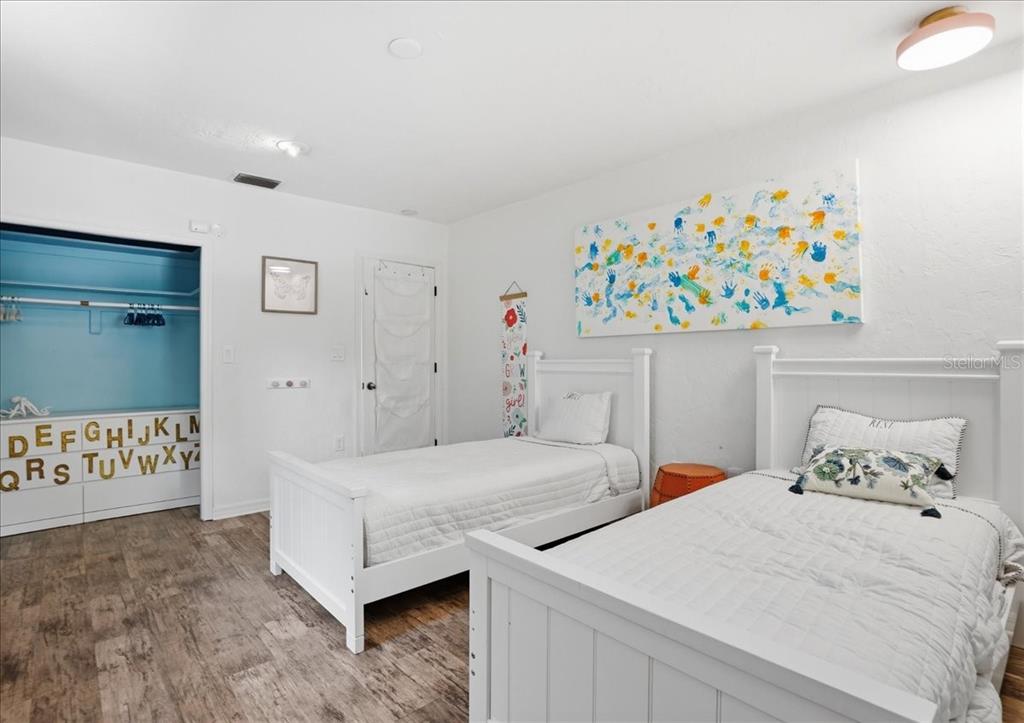 3127 Bay Shore Road Sarasota, FL 34234 - Photo 38 of 78 a bedroom with two beds and a baby crib