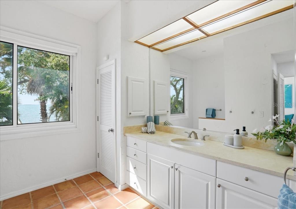 3127 Bay Shore Road Sarasota, FL 34234 - Photo 46 of 78 a bathroom with a sink and a mirror