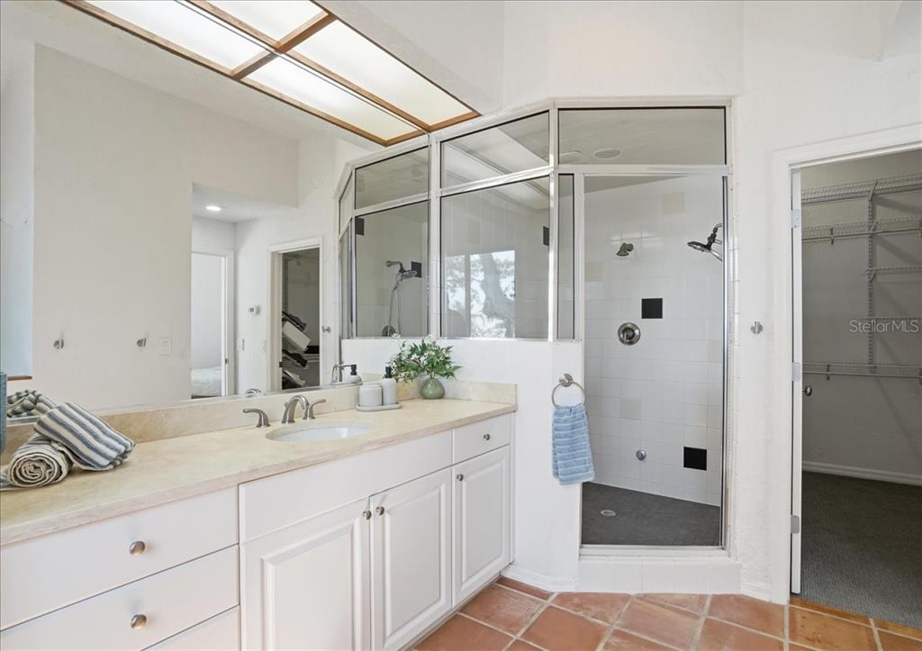 3127 Bay Shore Road Sarasota, FL 34234 - Photo 48 of 78 a spacious bathroom with a shower sink and mirror