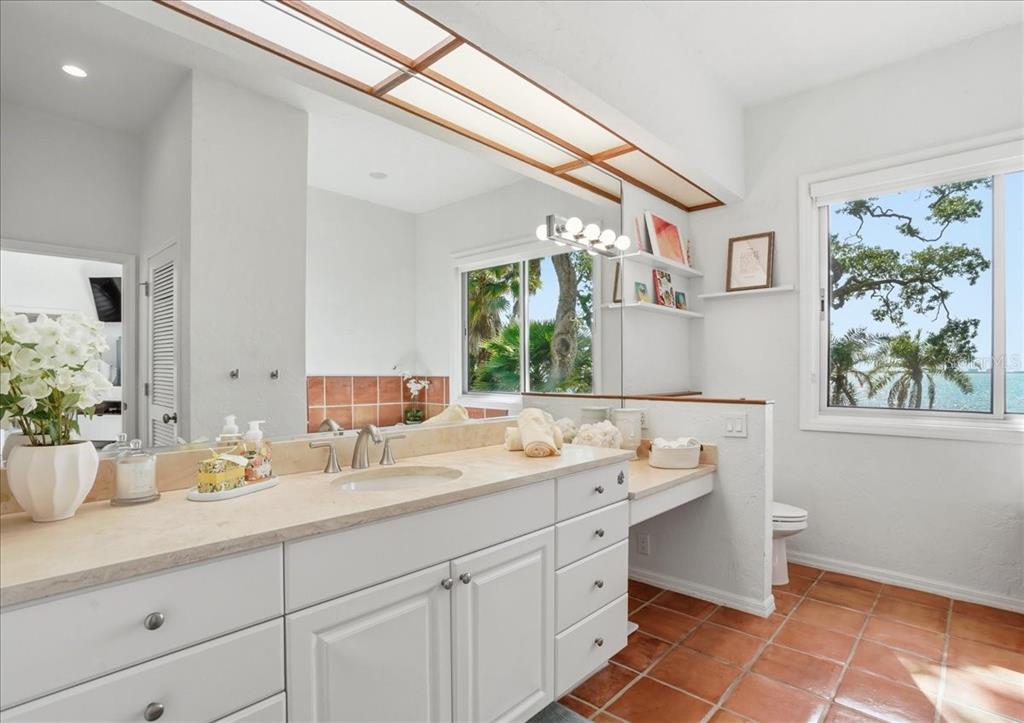 3127 Bay Shore Road Sarasota, FL 34234 - Photo 49 of 78 a bathroom with a sink and a mirror