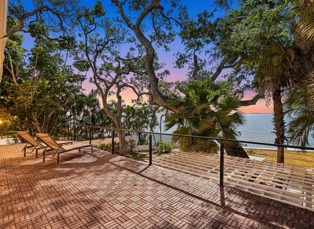 3127 Bay Shore Road Sarasota, FL 34234 - Photo 54 of 78 a view of backyard with wooden fence and large trees