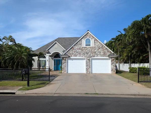 a view of a house with a yard and large trees
