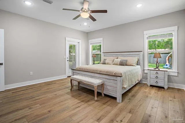 a bedroom with a bed and a large window