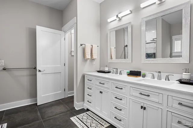 a bathroom with a double vanity sink and mirror
