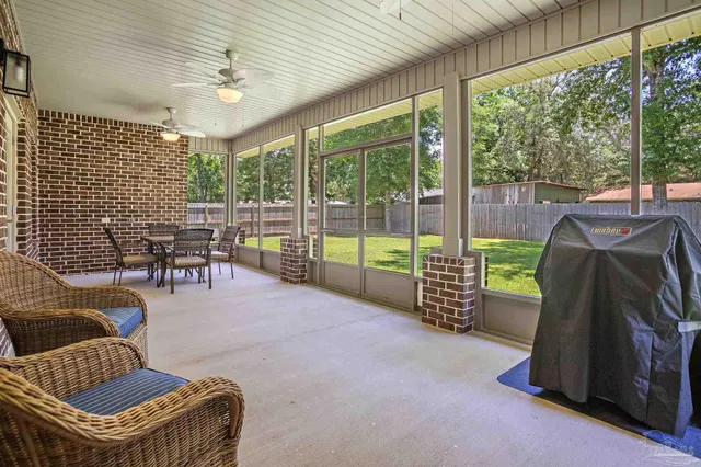 a living room with furniture and a floor to ceiling window