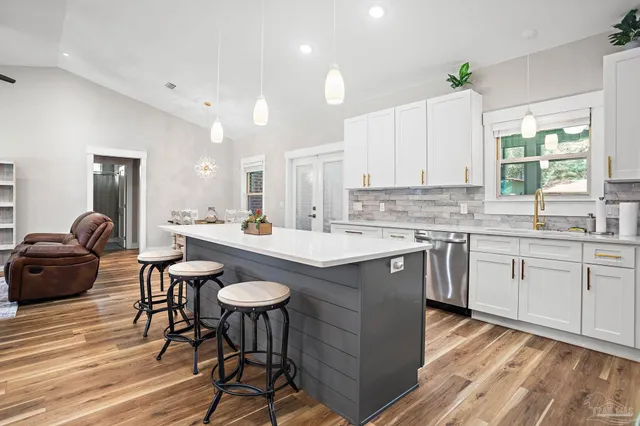 a kitchen with a table chairs sink and cabinets