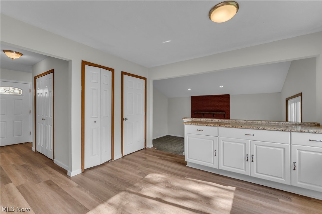 2540 Charney Road University Heights, OH 44118 - Photo 11 of 44 Open concept design featuring wood-finish flooring, white cabinetry, and a light-toned countertop