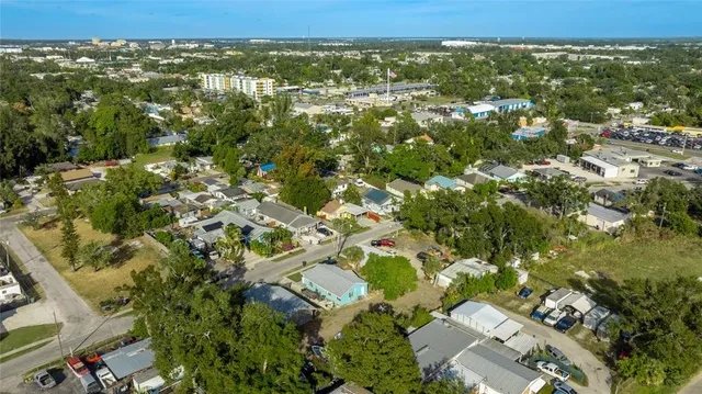 an aerial view of residential houses with city view