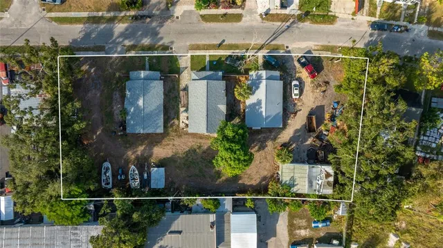 an aerial view of a house with garden space and street view