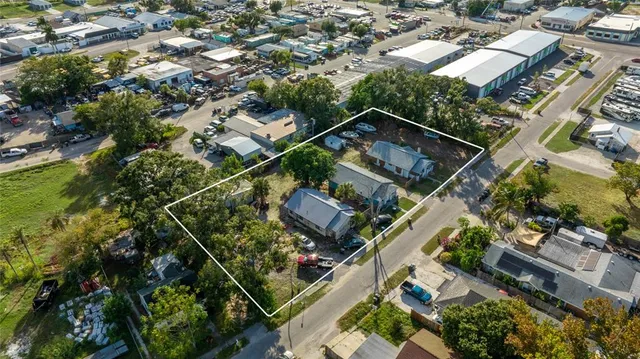 an aerial view of residential houses with green space