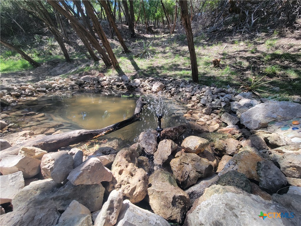 a water view of water with a house in the background