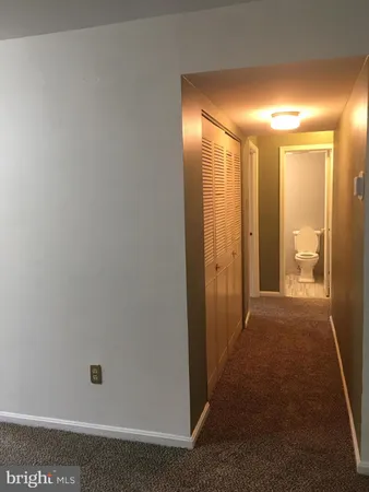 a view of hallway with bathroom