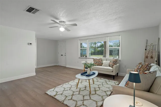 a living room with furniture and wooden floor