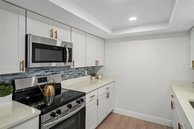 a kitchen with a sink stove and microwave