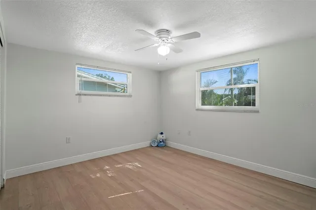 a view of room with window and ceiling fan